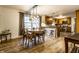 Charming dining room with hardwood floors, a modern light fixture, and a view of the open kitchen at 7671 Sherry Ln, Brownsburg, IN 46112