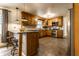 Well-appointed kitchen with stainless steel appliances, breakfast bar, and stone tile flooring at 7671 Sherry Ln, Brownsburg, IN 46112