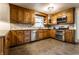 Modern kitchen featuring stainless steel appliances, tile backsplash, and ample cabinet space at 7671 Sherry Ln, Brownsburg, IN 46112