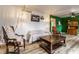 Inviting living room featuring wood-look floors and stylish decor and bright, contrasting green wall at 7671 Sherry Ln, Brownsburg, IN 46112