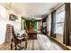 Bright living room with wood floors, ample natural light from large windows, and eclectic furnishings at 7671 Sherry Ln, Brownsburg, IN 46112