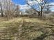 The backyard features a spacious lawn, bordered by a wooden fence and mature trees, creating a private outdoor space at 823 Collier St, Indianapolis, IN 46241