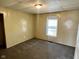 Carpeted bedroom featuring a window with blinds and an overhead light fixture at 823 Collier St, Indianapolis, IN 46241