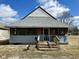 Inviting home with a unique roofline and covered porch with a wood entry at 823 Collier St, Indianapolis, IN 46241