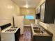 Traditional kitchen featuring wood-look flooring, double basin sink, and updated appliances at 823 Collier St, Indianapolis, IN 46241