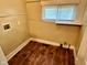 Simple laundry room with wood-look floor and window to allow for natural light at 823 Collier St, Indianapolis, IN 46241