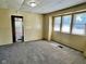 Carpeted living room with natural light with a view into another room at 823 Collier St, Indianapolis, IN 46241