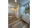 Bathroom features wood-look floors and white vanity with black hardware and a modern mirror at 8468 N Baltimore Rd, Monrovia, IN 46157