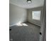 Small bedroom with plush carpets, a window, and neutral walls at 8468 N Baltimore Rd, Monrovia, IN 46157