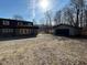 Exterior view showing a home and detached garage in a wooded, country setting at 8468 N Baltimore Rd, Monrovia, IN 46157