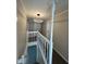 Hallway with plush carpets, white banister, and a decorative light fixture at 8468 N Baltimore Rd, Monrovia, IN 46157