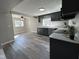 This modern kitchen offers grey cabinets, stainless steel appliances, and easy access to the dining area at 8468 N Baltimore Rd, Monrovia, IN 46157