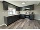 Updated kitchen with gray cabinetry, stainless steel appliances, stylish countertops, and modern flooring at 8468 N Baltimore Rd, Monrovia, IN 46157