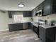 Modern kitchen with sleek gray cabinets, stainless steel appliances, and stylish countertops and flooring at 8468 N Baltimore Rd, Monrovia, IN 46157