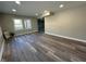 Living room with hardwood floors, many recessed lights, and multiple windows at 8468 N Baltimore Rd, Monrovia, IN 46157
