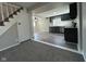 Open living space showcasing new flooring and modern paint tones, flowing into a stylish kitchen at 8468 N Baltimore Rd, Monrovia, IN 46157
