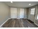 Neutral living room with hardwood floors, access to closets and an exterior door with a window at 8468 N Baltimore Rd, Monrovia, IN 46157