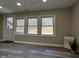 Sunlit living room features hardwood floors, three windows, and an exterior door at 8468 N Baltimore Rd, Monrovia, IN 46157