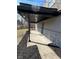 Covered porch with gray stone accents, siding, and black mulch in landscape beds at 8468 N Baltimore Rd, Monrovia, IN 46157