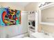 Well-lit bathroom featuring a shower-tub combination and a cabinet for storage at 8525 Edith St, Martinsville, IN 46151