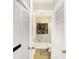 Cozy bathroom with a shower-tub combo, toilet, louvered door, and tiled flooring for comfort and convenience at 8525 Edith St, Martinsville, IN 46151