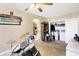Bedroom with a laundry area, featuring neutral walls, ceiling fan, open to the kitchen with drums and guitars at 8525 Edith St, Martinsville, IN 46151