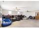 Spacious living room with carpet floor, ceiling fan, and natural light at 8525 Edith St, Martinsville, IN 46151