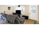 Cozy living room featuring plush seating, warm flooring, and a view of the entrance door and window at 8525 Edith St, Martinsville, IN 46151