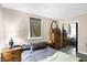 Calm main bedroom with soft lighting, a neutral palette, wood flooring, and a mirrored sliding-door closet at 8525 Edith St, Martinsville, IN 46151