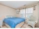 Cozy bedroom with a large window and wicker chair at 9694 River Oak E Ln, Fishers, IN 46038