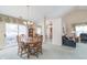 Inviting dining area with a chandelier, table for six, and view to outdoor patio at 9694 River Oak E Ln, Fishers, IN 46038