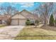 Inviting single-story home featuring a two-car garage and manicured front yard at 9694 River Oak E Ln, Fishers, IN 46038