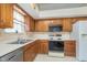 Charming kitchen with wood cabinets, a stainless steel dishwasher, and updated appliances at 9694 River Oak E Ln, Fishers, IN 46038