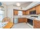 Cozy kitchen featuring wood cabinets, white countertops, and stainless steel dishwasher at 9694 River Oak E Ln, Fishers, IN 46038