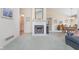 Cozy living room features a fireplace, neutral paint, and adjacent dining area at 9694 River Oak E Ln, Fishers, IN 46038