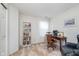 Bright home office with a desk, bookshelf, and comfortable seating at 9694 River Oak E Ln, Fishers, IN 46038