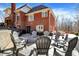 The backyard features a patio with chairs and a view of the brick house at 11850 Deer Walk Dr, Cicero, IN 46034