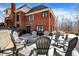 The backyard features a patio with chairs and a view of the brick house at 11850 Deer Walk Dr, Cicero, IN 46034