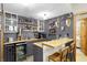 Stylish home bar area with wine fridge, custom cabinetry, and wooden countertops at 11850 Deer Walk Dr, Cicero, IN 46034