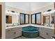 Primary bathroom with a garden tub, dual vanities, neutral color palette, and natural light at 11850 Deer Walk Dr, Cicero, IN 46034