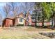 Charming brick home with a stone retaining wall, mature trees, and well-maintained landscaping at 11850 Deer Walk Dr, Cicero, IN 46034