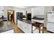 Well-lit kitchen featuring white cabinets, granite countertops, and stainless steel appliances at 11850 Deer Walk Dr, Cicero, IN 46034