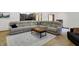Expansive living area featuring a large sectional sofa and a wooden coffee table on a patterned rug at 11850 Deer Walk Dr, Cicero, IN 46034