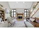 Living room with cathedral ceiling, fireplace, staircase, hardwood floors, and ample natural light at 11850 Deer Walk Dr, Cicero, IN 46034