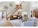 Bright open-concept living room with a staircase and views into the dining area at 11850 Deer Walk Dr, Cicero, IN 46034