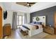 Spacious main bedroom with a tray ceiling, wood accent wall, bench, and natural light at 11850 Deer Walk Dr, Cicero, IN 46034