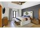 Spacious main bedroom with a tray ceiling, wood accent wall, bench, and natural light at 11850 Deer Walk Dr, Cicero, IN 46034