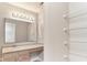 Bathroom featuring large mirror with vanity lighting, sink and ample shelving for storage at 12243 Belfry Dr, Noblesville, IN 46060