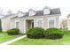 Charming home featuring dormer windows, black front door, and lush green bushes framing the entrance at 12243 Belfry Dr, Noblesville, IN 46060