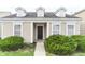 Charming home featuring dormer windows, black front door, and lush green bushes framing the entrance at 12243 Belfry Dr, Noblesville, IN 46060